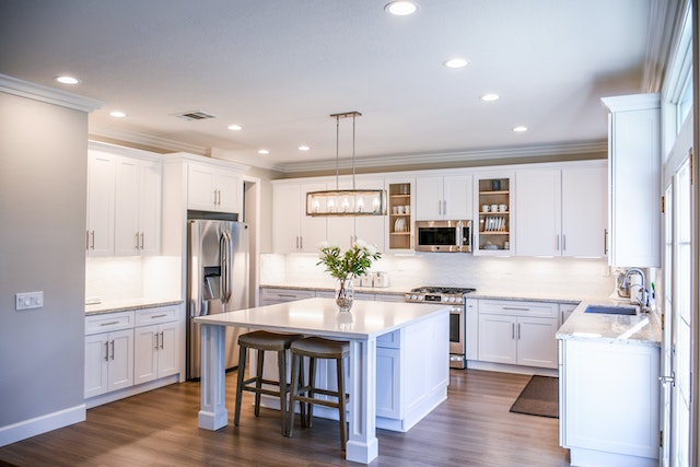 A white kitchen with furniture and appliances.