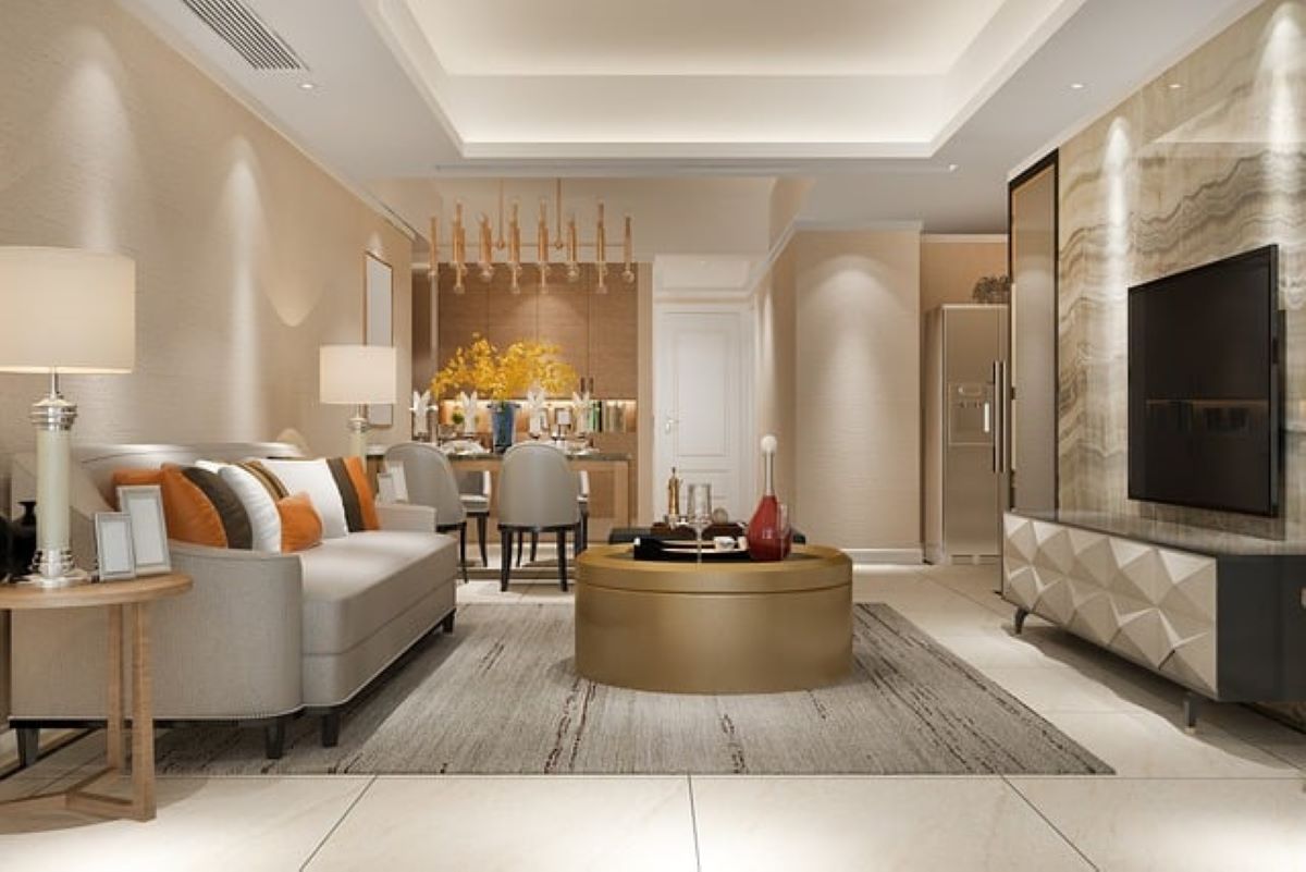 Plan your interior design layout before moving in to organize a living room with neutral colors and a large golden coffee table