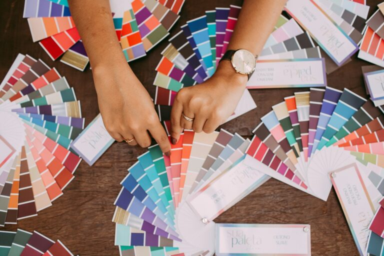 Woman’s hands looking through color swatches